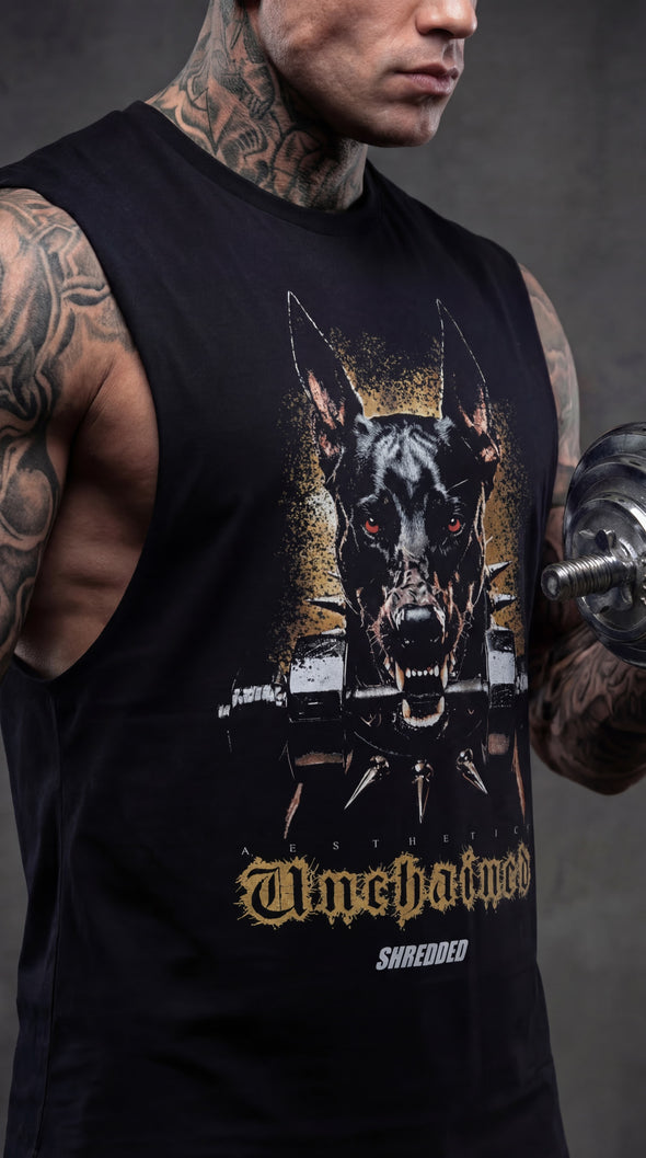 Person wearing a black sleeveless shirt with a graphic design of a dog and text, holding a dumbbell.