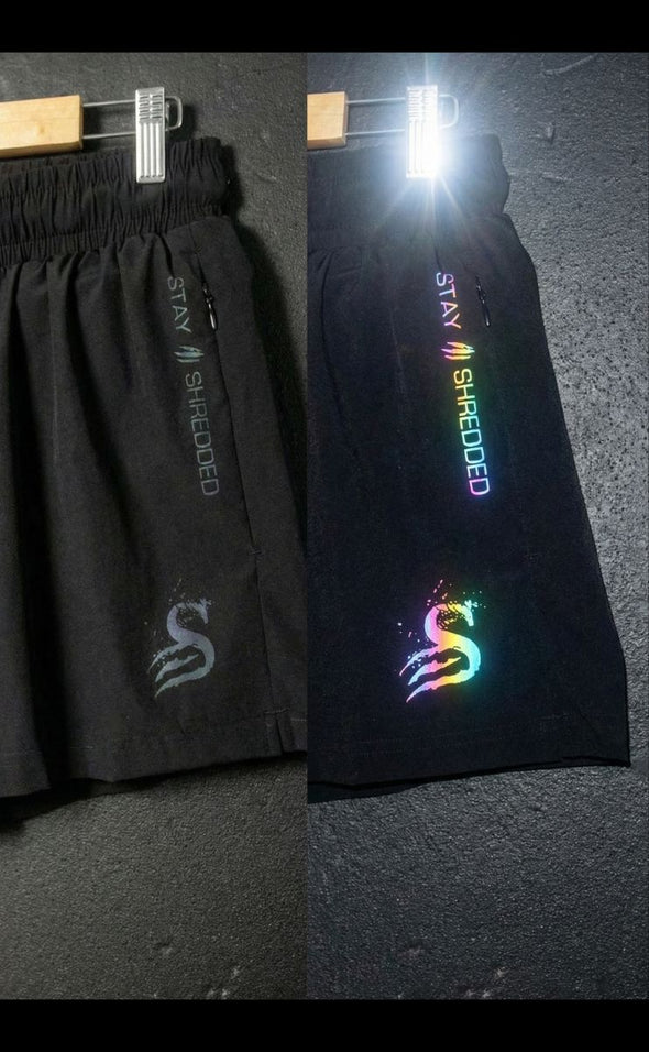 Trip Reflective gym shorts Australia showing colour changing effect - mens reflective gym shorts before and after flash with iridescent rainbow logos Stay Shredded