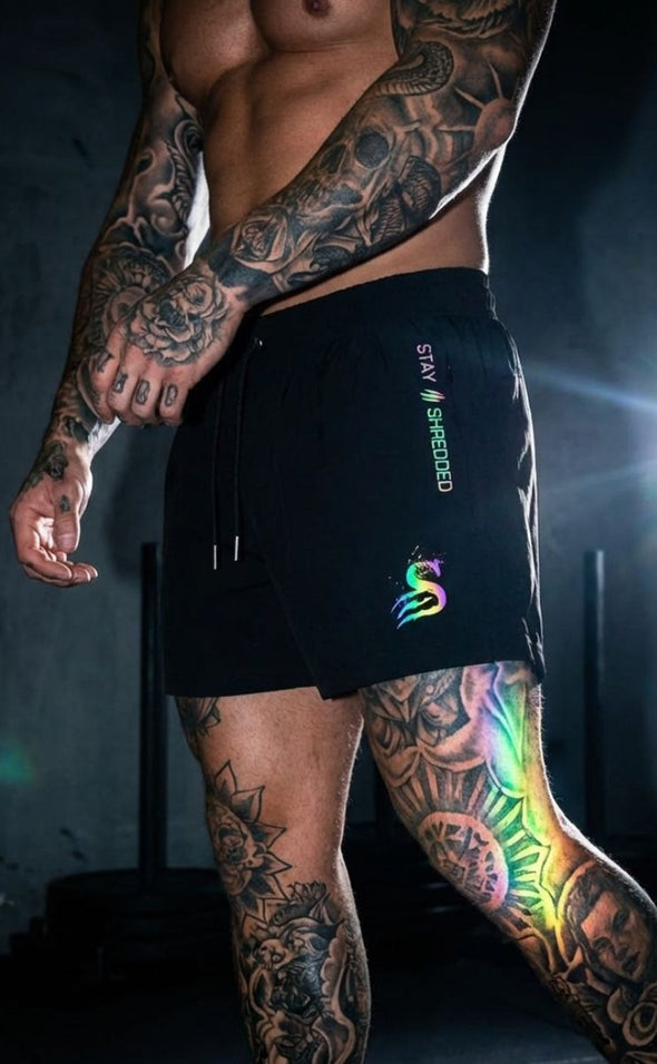 Trip Reflective gym shorts mens Australia showing rainbow iridescent effect on legs - artistic gym lighting photo of colour changing leg day shorts Stay Shredded