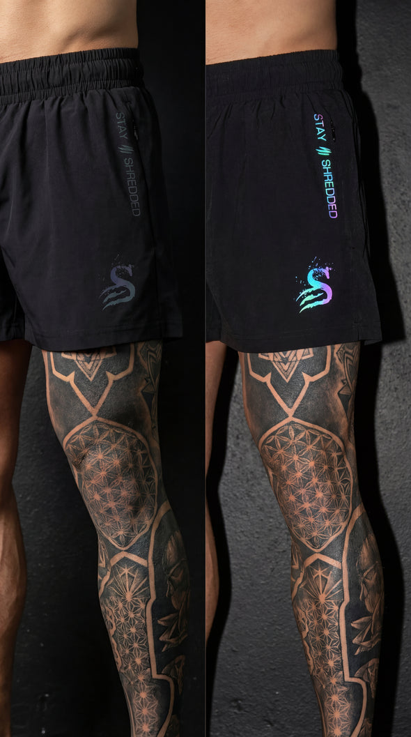 Trip Reflective leg day shorts Australia close-up showing iridescent colour changing Stay Shredded logos on black mens gym shorts before and after flash