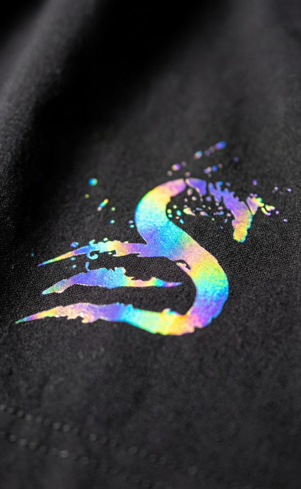 Trip Reflective logo close-up on gym shorts showing iridescent colour shift - Stay Shredded S logo with rainbow holographic effect on mens leg day shorts